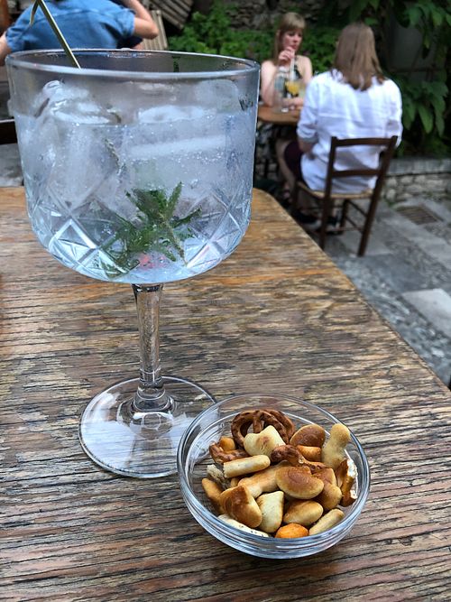 Etna Gin with tonic and Rosemary sprig. Little snacks they give with the drinks (waiter confirmed they were vegan) at Timoleone Veggie Restaurant & Cocktail Bar in Taormina