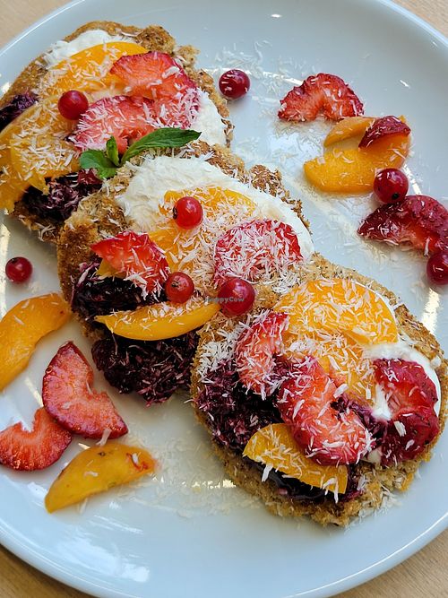 Millet buckwheat pancakes, cashew yogurt, jam and fruit at Namu ნამუ - Online in Tbilisi