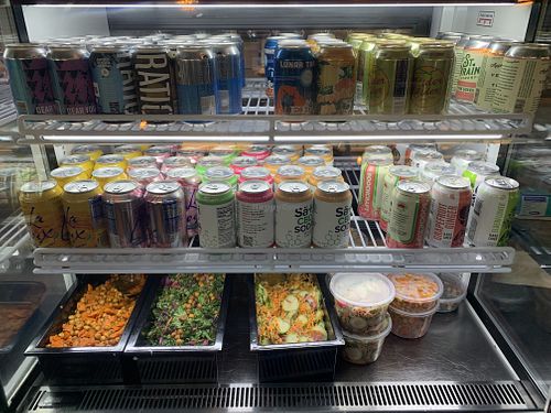 Cold case with drinks and salad. at Watercourse Foods in Denver