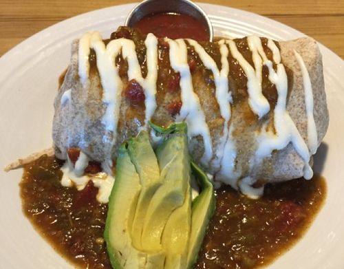 BREAKFAST BURRITO (Refried black beans and your choice of home fries, sweet potatoes, or rice, wrapped in a tortilla and smothered with gravy or green chili) at Watercourse Foods in Denver