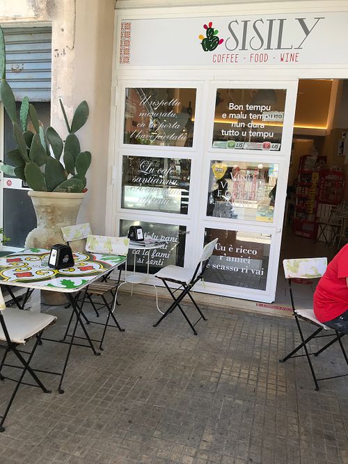Curbside seating with car fumes at Sisily in Noto