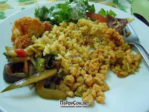 Lunch plate, with fried corn fritter, rice, TVP, Thai stir fry, salad, and fake meat. at Girasoles Restaurante Vegetariano in Cartagena