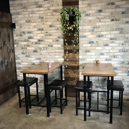 A few tables inside, a counter and outside seating in summer at Simply Pressed Juice in Granger