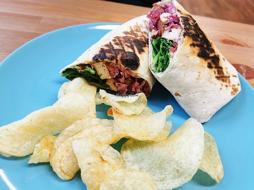 Crispy tofu toasted wrap with crisps. #vegan at Peacock Cafe in Stanmore
