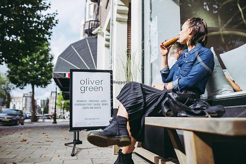 Enjoying some juice outside  at Oliver Green - East in Amsterdam