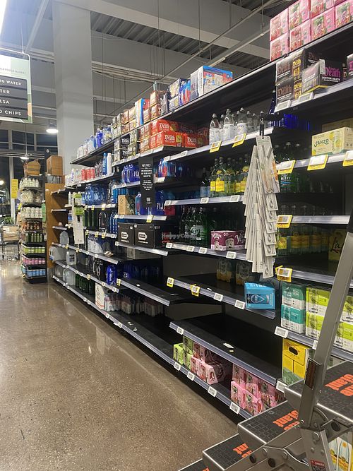 Empty Shelves in the Water Aisle - Liquid Death Spotted $9.99 for Iced Tea  at Whole Foods Market - P St in Washington