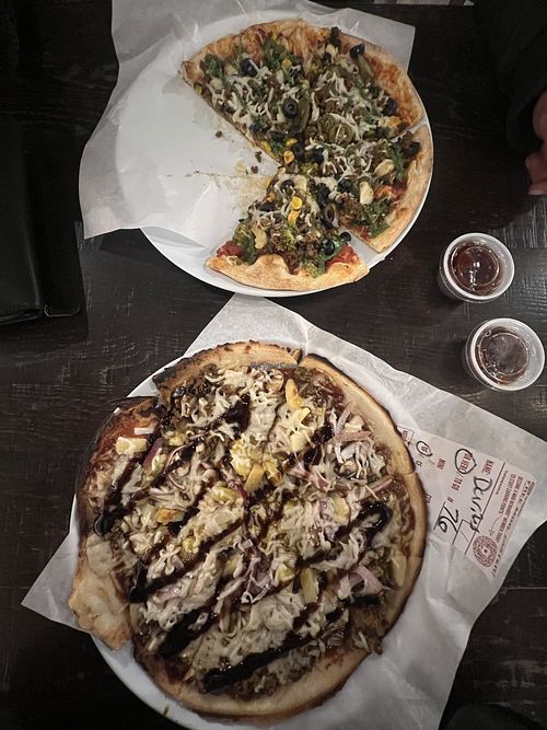 Both have vegan cheese and beyond meat. Top has regular crust wed red sauce and veggies, mine is bbq sauce with pineapple onion garlic, both delicious  at Mod Pizza in Sierra Vista