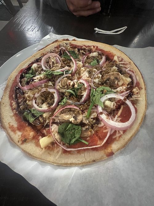 Gluten free crust with red sauce, plant based cheese and sausage, onion, pineapple, mushroom, and balsamic glaze, quite good!  at Mod Pizza in Sierra Vista