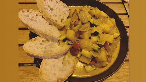 Vegetables and roots in a coconut milk yellow curry served with local bread at Pearl in Ericeira