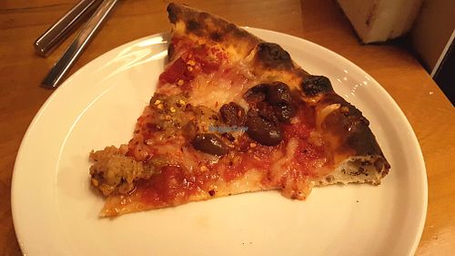Vegan pizza with cheese and sausage at Delarosa - Chestnut St in San Francisco