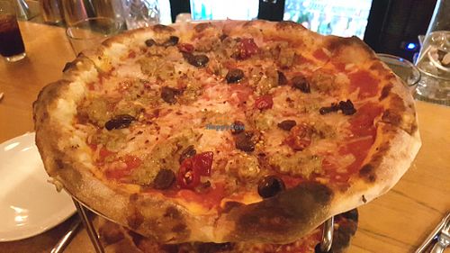 Vegan pizza with cheese and sausage at Delarosa - Chestnut St in San Francisco