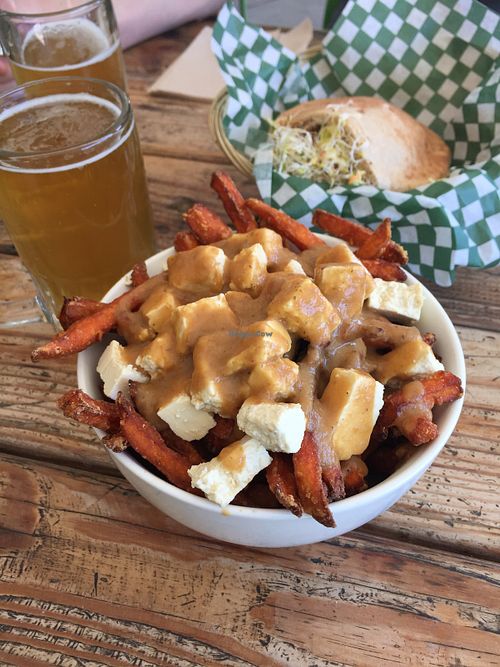 Poutine, beer, and the classic falafel sandwich! at Panthere Verte - Mile End in Montreal