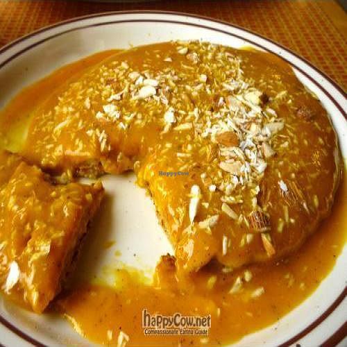 Cardamom flavored pancakes with mango puree and slivered almonds on top...Yum! at Annapurna's World Vegetarian Cafe - 4th St in Albuquerque