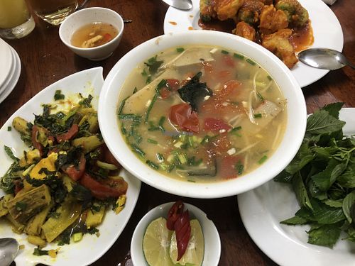 Seafood noodles, banana tomato dish, fried cauliflower and broccoli  at Hà Thành in Hanoi