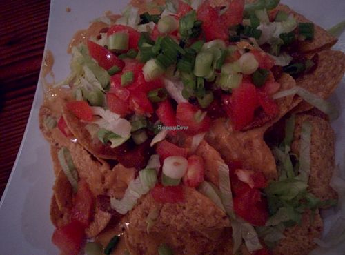 Souley Vs tastily delicious Chickin seitan nachos, 
Tortilla chips topped w/ our house made vegan creole style vegan nacho cheesee,  house made seitan “Chick” strips,  green onion, finely chopped lettuce, diced tomato. at Souley Vegan in Oakland