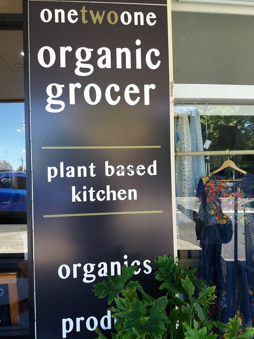 Outside signage at 1Two1 Vegan Café in Springwood
