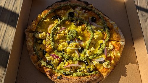 Scrambled-tofu pizza by Wildwood Pizza at Vegan Night Market in Christchurch