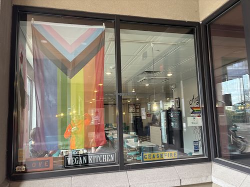 Gay pride flag and “ceasefire” signn show their at Angelhearts Donuts in Ithaca