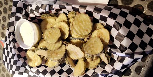 Fried pickles,with a tiny amount of sauce and they charge $.75 for every extra one at Sputnik in Denver