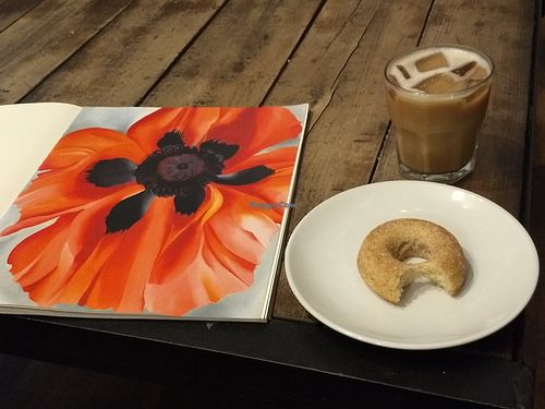 Vegan donut, iced coffee, Georgia O'Keefe book at Silk City Coffee in Manchester