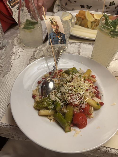 "Asparagus & Couscous" with roasted, caramelized green asparagus,
grilled cherry tomatoes, pomegranate seeds, and toasted almond flakes (seasonal dish)  at Marchfelderhof in Deutsch-wagram