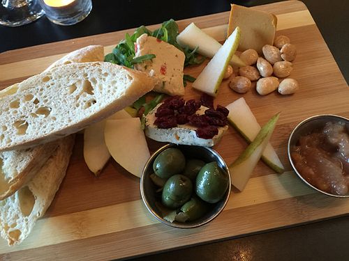 Cheese Plate 
Can be made GF 
herb chevre, cheddar, pepper jack, marcona almonds, pear chutney, roasted olives, seasonal fruit, and toasted baguette at Blossoming Lotus - Irvington in Portland