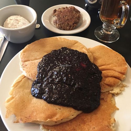 Buttermilk pancakes with marionberry compote and coconut whipped cream on the side!! at Blossoming Lotus - Irvington in Portland