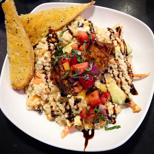Lunch special (vegan option): Jerk tofu in a coconut ginger sauce served over Israeli couscous, with a strawberry-jicama salsa and balsamic glaze. at Nine Mile Montford in Asheville