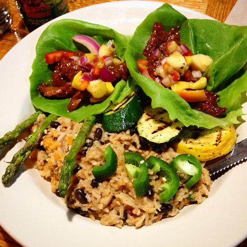 Dinner special: Caribbean lettuce wraps with jerked seitan, pickled onions, bell peppers, mangos, and jalepeños. With coconut cook up rice (with plenty of habaneros added), grilled veggies, and a spicy banana salsa. at Nine Mile Montford in Asheville