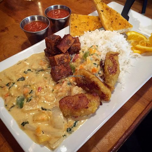 Nine Mile Montford lunch special (vegan option): Jerk tofu served with onions, mango, grilled pineapple and bell peppers saluted in a red curry coconut sauce over basmati. at Nine Mile Montford in Asheville