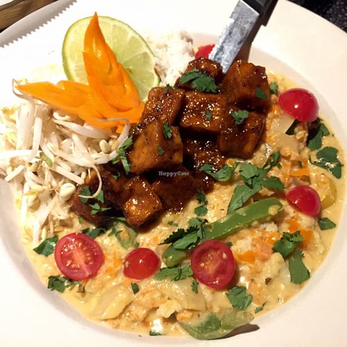 Dinner special on the west side tonight: Maple chipotle tofu with onions, peppers, and cauliflower in a green coconut curry sauce finished with cilantro,mung bean sprouts, and cherry tomatoes.  at Nine Mile Montford in Asheville