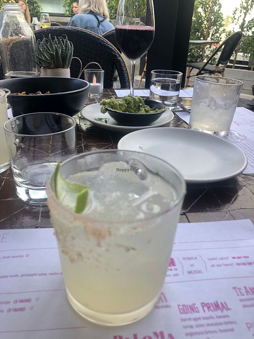 Margarita  with an amazing guacamole half destroyed in the background. at Gracias Madre in Newport Beach