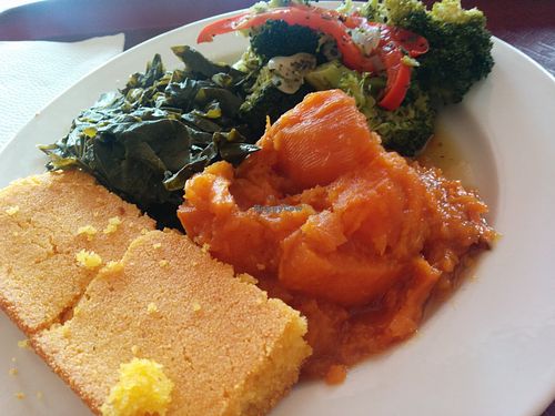 Veggie sampler plate - what the non-vegan ordered. Why some people have a "thing" about eating vegan amazes me! It's just food, cruelty free. Moist, tasty cornbread, with sweet potatoes, collard greens and a broccoli stir-fry. She kept inspecting every bite of the stir-fry looking for hidden tofu - really... at Soul Vegetarian - South in Atlanta