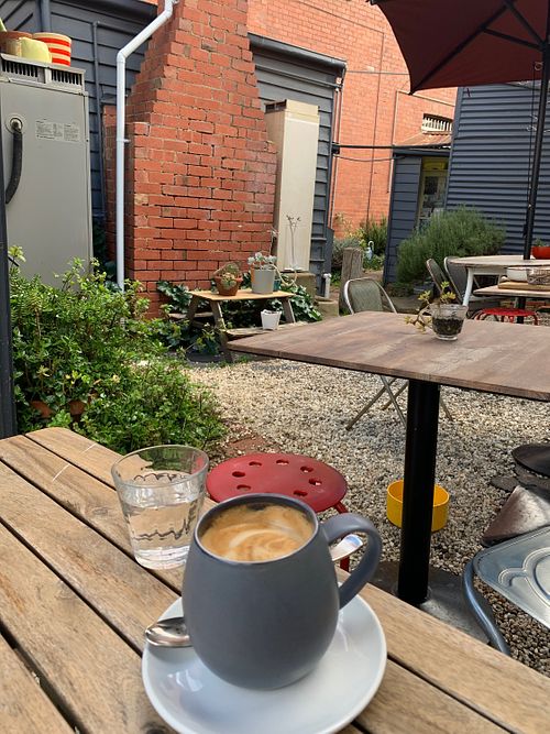 courtyard with almond latte (stayed very warm in this thick mug) at Olivia's Pantry in Kyneton