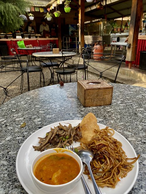 Breakfast buffet: vegan tarkari, puri, sautéed mushrooms and fried noodles  at Utpala Café in Kathmandu