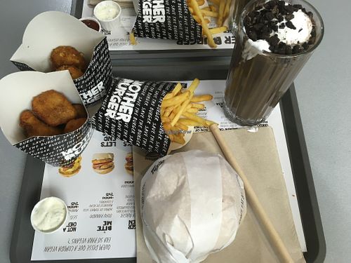 Mother burger menu and appetizers (Cheese balls and seitan nuggets) with milkshake. at Mother Burger - Saldanha in Lisbon