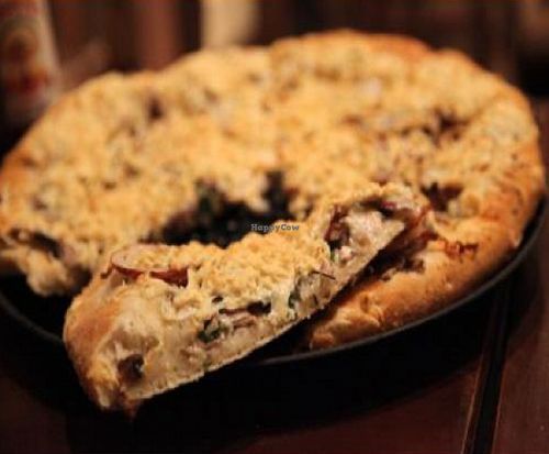 medium pizza with daiya cheese, basil, roasted red potatoes, mushroom blend, and vegan garlic cream sauce at Pizza Guru in Santa Barbara