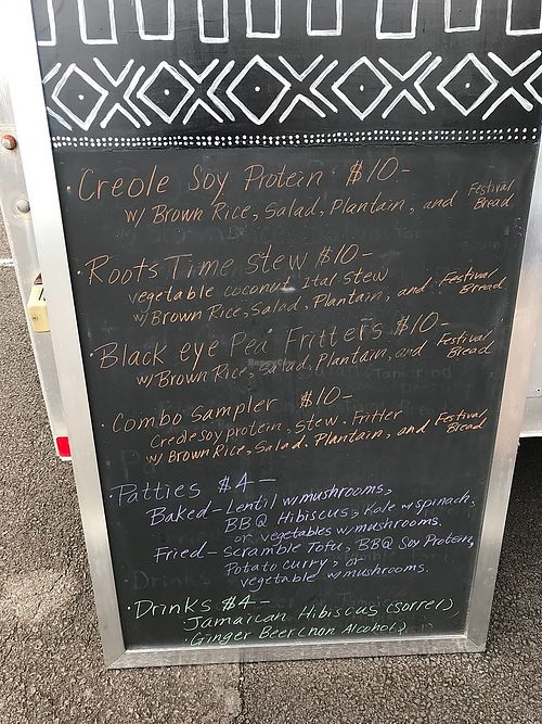 Menu board, changes frequently at Roots Time vegan wagon in Hilo