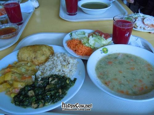 Lunch plate @ Zukini with fried fake ham empanada, two kinds of 'curry', rice, salad, quinoa soup, and juice. at Vegetariano Zukini in Bogota