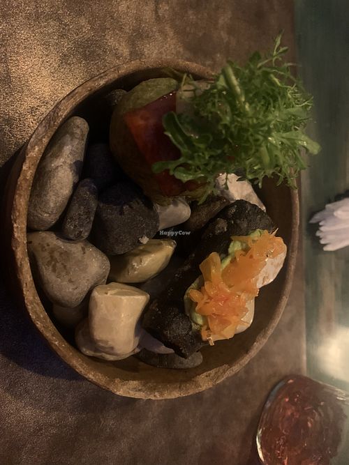 Appetizer, served on bed of rocks, includes ball of deep fried guacamole that also looks like a rock  at Teocintle - Tika'aya in Oaxaca