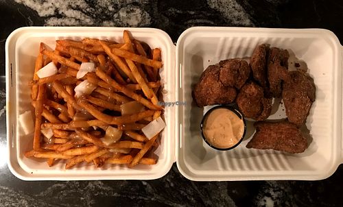Seitan’s poutine and salt n’ pepper chick’n wings at Seitans Disciples in Edmonton
