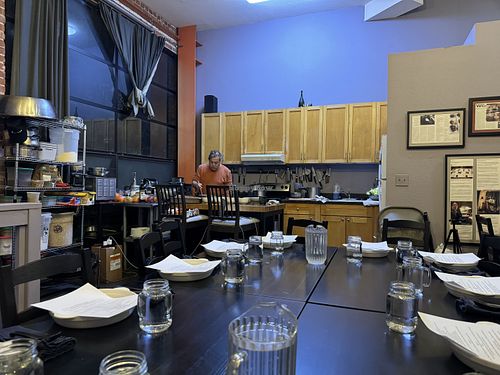 Table set and Chef Philip working away   at Sound & Savor in Oakland