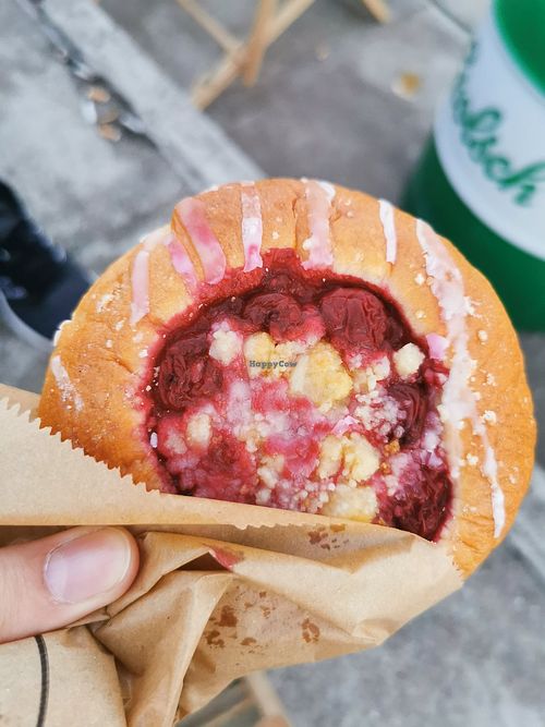 Vegan yeast bun with cherries and crumble. Very good. at Bread House in Torun
