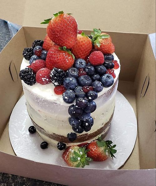 Any Occasion Vegan Cake, iced semi naked with fruit at Petunia's Bakery in Pensacola