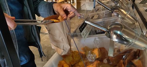 Filling paper bag with product at Salud a Granel in Tijuana