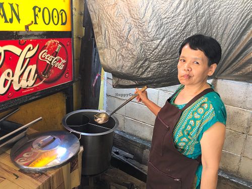 Friendly vegan woman serving soup at J La Thip in Lampang