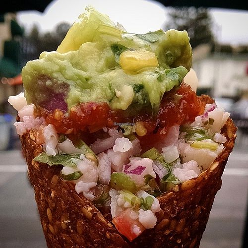 The Epic Cone: Sunflower Seed Refried Beans, with layers of guacamole, cauliflower ceviche, mango salsa, and chili d'ablo salsa at RawDaddy Foods in Palo Alto