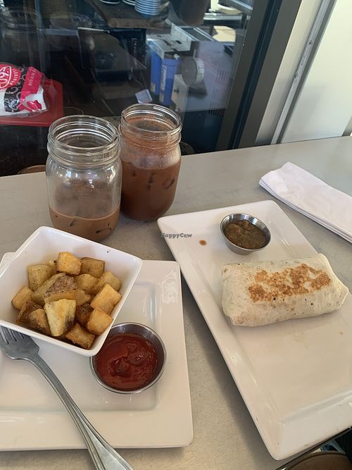 Vegan orange mocha lattes and breakfast burrito! Side of potatoes.  at Zenzero Kitchen in Coppell
