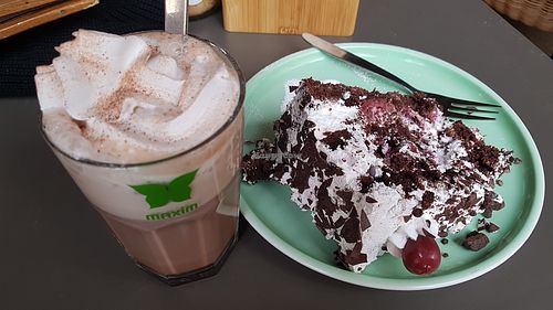 Hot chocolate with Cream and cherry chocolate cream cake at Katzentempel in Regensburg