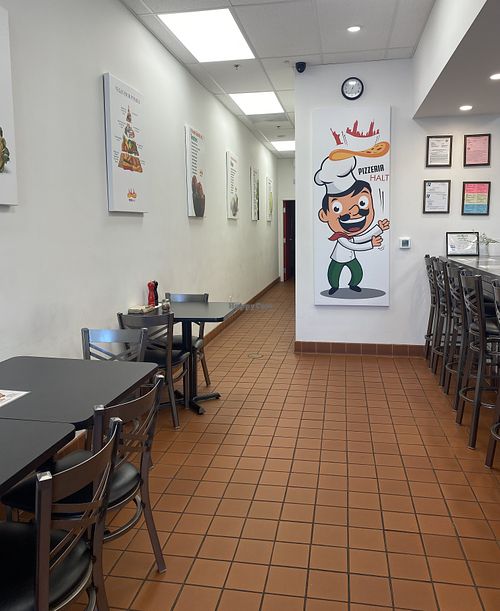 Clean and Streamline Indoor Seating Area w/Vegan Posters  at Pizzeria Halt in Modesto